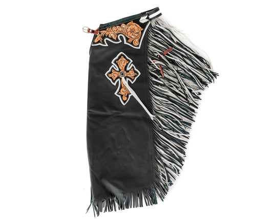 A pair of adult stock chaps in black and white with tooled yokes, white trim and fringe, and two buckles.